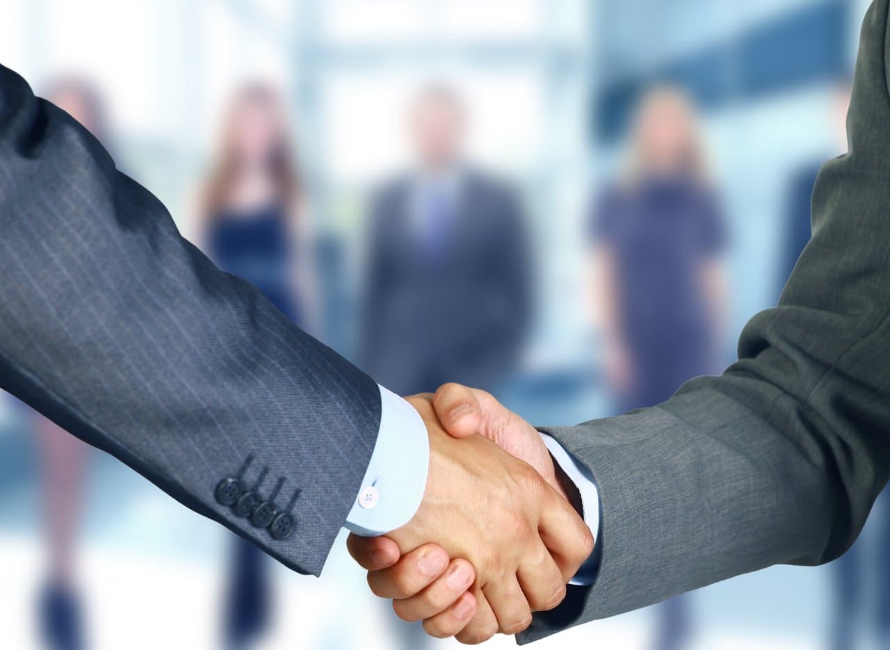 Two-businessmen-shake-hands-3168×2315